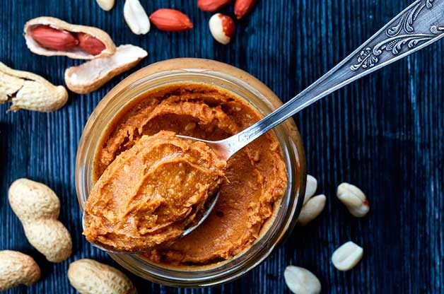 spoon balanced on jar of peanut butter