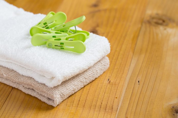 housekeeper folding towels & clothes