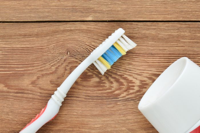 Toothbrush and toothpaste on a wooden table. The beauty and health of your teeth. The concept of dental care.