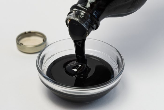 hummingbird mixture, Molasses In Bowl Over White Background
