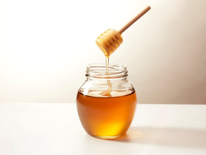 Glass jar of honey ready to be severed