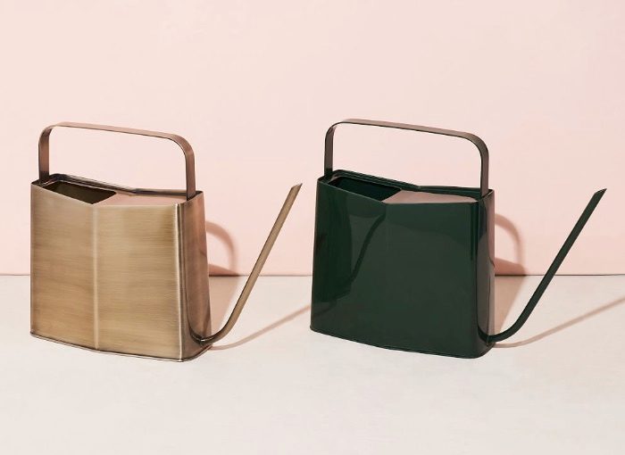 Square decorative watering cans in a shiny black and matte gold.