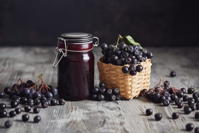 Aronia jam next to fresh berries